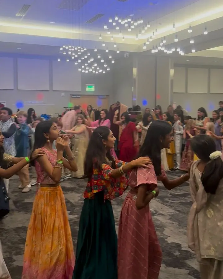 Students and families dancing at a school Diwali celebration